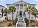 Stately two-story home with a grand entrance staircase and classic architectural details at 1636 Rivertowne Country Club Dr, Mount Pleasant, SC 29466