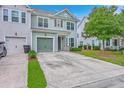 Charming two-story home featuring a green garage door and manicured lawn at 1666 Bridwell Ln, Mount Pleasant, SC 29466