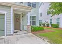 Inviting front entrance with decorative wreath, brick accents and a flower bed at 1666 Bridwell Ln, Mount Pleasant, SC 29466