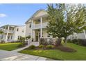 Charming two-story home featuring a welcoming porch, balcony, and beautifully landscaped front yard at 1713 Banning St, Mount Pleasant, SC 29466