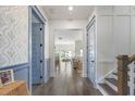 Inviting hallway features elegant decor, beautiful wainscoting, and seamless transition to the living spaces at 1713 Banning St, Mount Pleasant, SC 29466