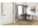 A cozy dining room features a round table, comfortable seating and neutral decor, creating an inviting atmosphere at 1751 Cultivation Lane Dr # 498, Mount Pleasant, SC 29466