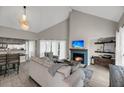 Inviting living room with vaulted ceilings, a cozy fireplace, and modern decor at 202 Mariners Cay Dr, Folly Beach, SC 29439