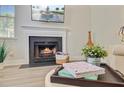 Cozy fireplace featuring a white mantel, with decorative books and plants on a nearby ottoman at 2404 Fulford Ct, Mount Pleasant, SC 29466