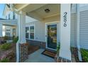 Inviting front porch showcasing the home's address, classic columns, and a charming welcome mat at 286 Godwit Dr, Summerville, SC 29486