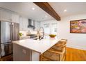 Bright kitchen with granite island, stainless steel appliances, open floor plan and hardwood floors at 31 Lyttleton Ave, Charleston, SC 29407