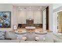 Kitchen pass-through featuring white cabinetry and a marble countertop with seating at 32 Prioleau St # J, Charleston, SC 29401
