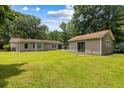 Spacious backyard featuring a well-maintained lawn, a detached garage and an attached building at 3347 Walter Drive, Johns Island, SC 29455