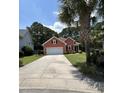 Charming single-story home with an attached two-car garage, beautiful landscaping, and a long driveway at 350 Cypress Walk Way, Wando, SC 29492