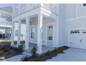 Close-up exterior view of charming two-story home with light blue door and attached two car garage at 444 Parish Farms Dr, Summerville, SC 29486