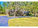 Well-maintained brick house featuring a spacious yard and a covered porch at 4715 Highway 165, Meggett, SC 29449