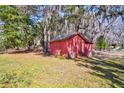 Red shed in a lush, partially shaded backyard at 4715 Highway 165, Meggett, SC 29449