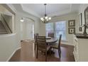 Elegant dining room features a trey ceiling, modern chandelier, and hardwood floors at 5011 W Liberty Meadows Dr, Summerville, SC 29485