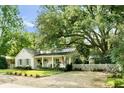 Lovely single-story home boasting lush landscaping, a welcoming front porch, and a charming white picket fence at 509 Klein St, Mount Pleasant, SC 29464