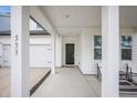 Inviting covered porch with seating and modern columns, enhancing curb appeal at 533 Richfield Way, Summerville, SC 29486