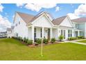 Beautifully landscaped two-story home featuring a well-manicured lawn and inviting front porch at 725 Maynard Ln, Summerville, SC 29486