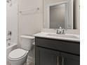 Modern bathroom with white quartz counters, gray vanity, and tub at 736 Maynard Ln, Summerville, SC 29486