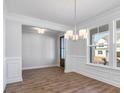 Bright dining room with elegant wainscoting, hardwood floors, and stylish light fixture at 770 Maynard Ln, Summerville, SC 29486