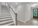 Hallway with a staircase and a decorative front door featuring sidelights and transom window at 773 Maynard Ln, Summerville, SC 29486