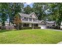 Traditional home featuring symmetrical facade, covered front porch, and manicured landscaping at 8328 Berringer Bluff, North Charleston, SC 29418