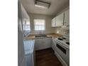 Efficient kitchen with white appliances, compact design, and functional layout at 867 Colony Dr # F 118, Charleston, SC 29407