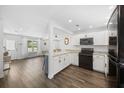 Bright kitchen featuring white cabinetry, stainless steel appliances, breakfast bar, and views to the living area at 8767 Auburn Dr, North Charleston, SC 29406