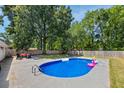 Backyard with an inviting in-ground pool and a spacious patio area, perfect for outdoor relaxation at 8767 Auburn Dr, North Charleston, SC 29406