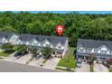Aerial view of a residential community with well-maintained homes, driveways, and lush green trees at 9079 Parlor Dr, Ladson, SC 29456