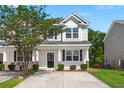 Charming two-story home with a welcoming front porch, well-manicured lawn, and a concrete driveway at 9079 Parlor Dr, Ladson, SC 29456