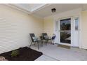 Inviting front porch with chairs and decor, offering a cozy spot to relax outdoors at 9091 Delancey Cir, North Charleston, SC 29406