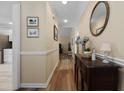 Bright hallway with wood floors, leading to other areas of the home at 9091 Delancey Cir, North Charleston, SC 29406