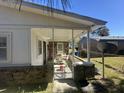 Cozy back porch with outdoor seating; ideal for relaxing and enjoying the backyard at 980 Margaret Dr, Ladson, SC 29456