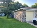 Side view of brick home with detached garage and driveway; ample parking space at 980 Margaret Dr, Ladson, SC 29456