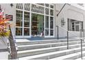 Elegant entryway with white stone steps, glass doors, and classic architectural details at 1 King # 702, Charleston, SC 29401