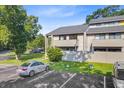 Exterior view of the two-story condo building with manicured lawn and parking on a partly sunny day at 1001 Waterwood Dr, Goose Creek, SC 29445