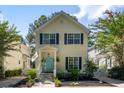 Beautiful two-story home with blue door, lush landscaping, and inviting front porch with flag at 1033 Mathis Ferry Rd, Mount Pleasant, SC 29464