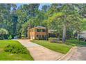 Spacious home with a long driveway, attached garage, and well-maintained lawn at 105 Greendale Ct, Summerville, SC 29485