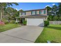 Beautiful two-story home featuring a manicured lawn and an attached two-car garage at 106 Sioux Ct, Summerville, SC 29483