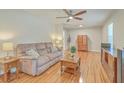 Bright living room featuring hardwood floors and a plush sofa at 110 Clubhouse Rd, Summerville, SC 29483