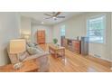Comfortable living room with hardwood floors, ceiling fan, and abundant natural light at 110 Clubhouse Rd, Summerville, SC 29483
