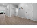Hallway with wood floors and white doors creates a bright, clean aesthetic at 1136 Kane Blue, Summerville, SC 29485