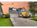 Beautiful two-story home featuring an attached garage and a welcoming front porch at 114 Marshside Dr, Summerville, SC 29485