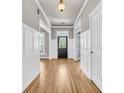 Bright foyer featuring hardwood floors, elegant trim work, and a welcoming front door at 114 Marshside Dr, Summerville, SC 29485
