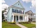 Beautiful two-story home featuring a covered front porch and lovely landscaping at 1150 Oak Bluff Ave, Charleston, SC 29492