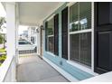 Cozy front porch with white columns and black shutters, perfect for relaxing at 1150 Oak Bluff Ave, Charleston, SC 29492