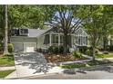 Inviting single-story home with mature trees, front porch and a two-car garage at 116 Cartright St, Daniel Island, SC 29492