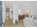 Open-concept living area with lots of natural light and hardwood floors throughout at 116 Cartright St, Daniel Island, SC 29492