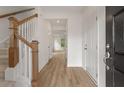 Inviting entryway with wood flooring and staircase with wooden banister at 117 Palfrey Dr, Ridgeville, SC 29472