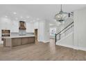 Spacious kitchen featuring a large island, wooden accents, and modern lighting fixtures at 1183 Reserve Ln, Awendaw, SC 29429