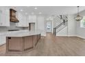 Bright, open kitchen with white cabinets, quartz countertops, and stainless steel appliances at 1183 Reserve Ln, Awendaw, SC 29429